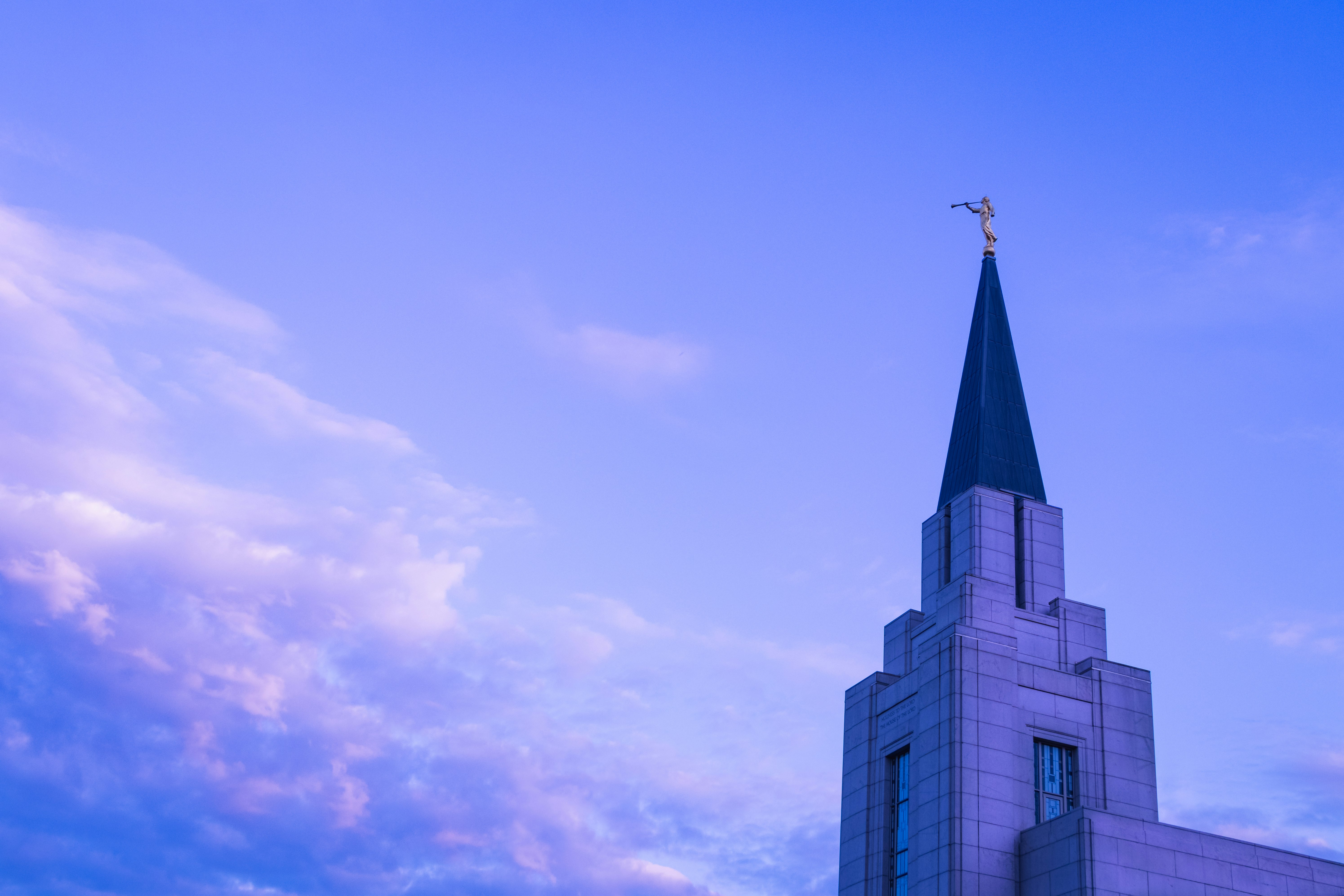 white cross on top of building during daytime